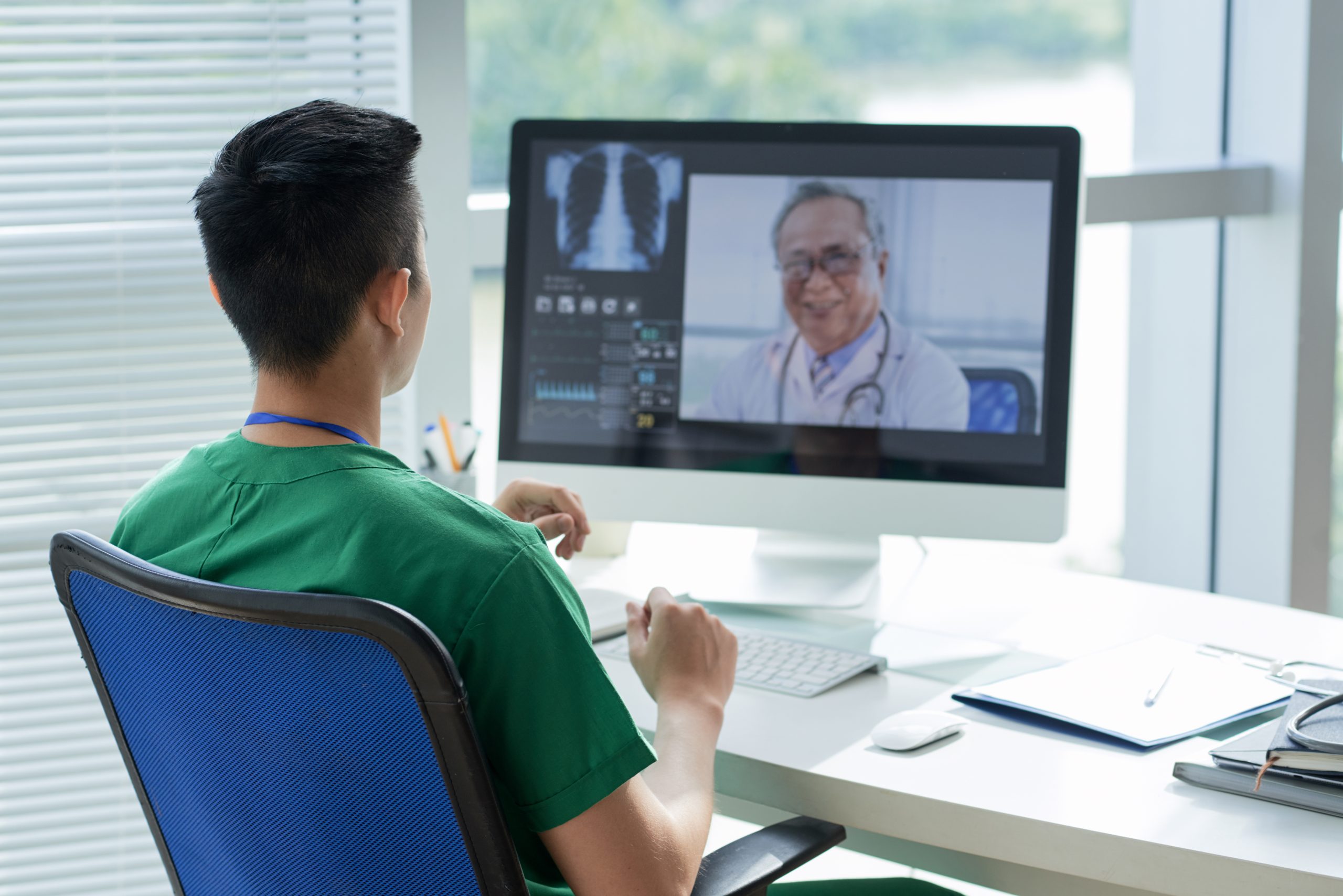 Video conference with doctor Young doctor talking to his experienced colleague via video conference