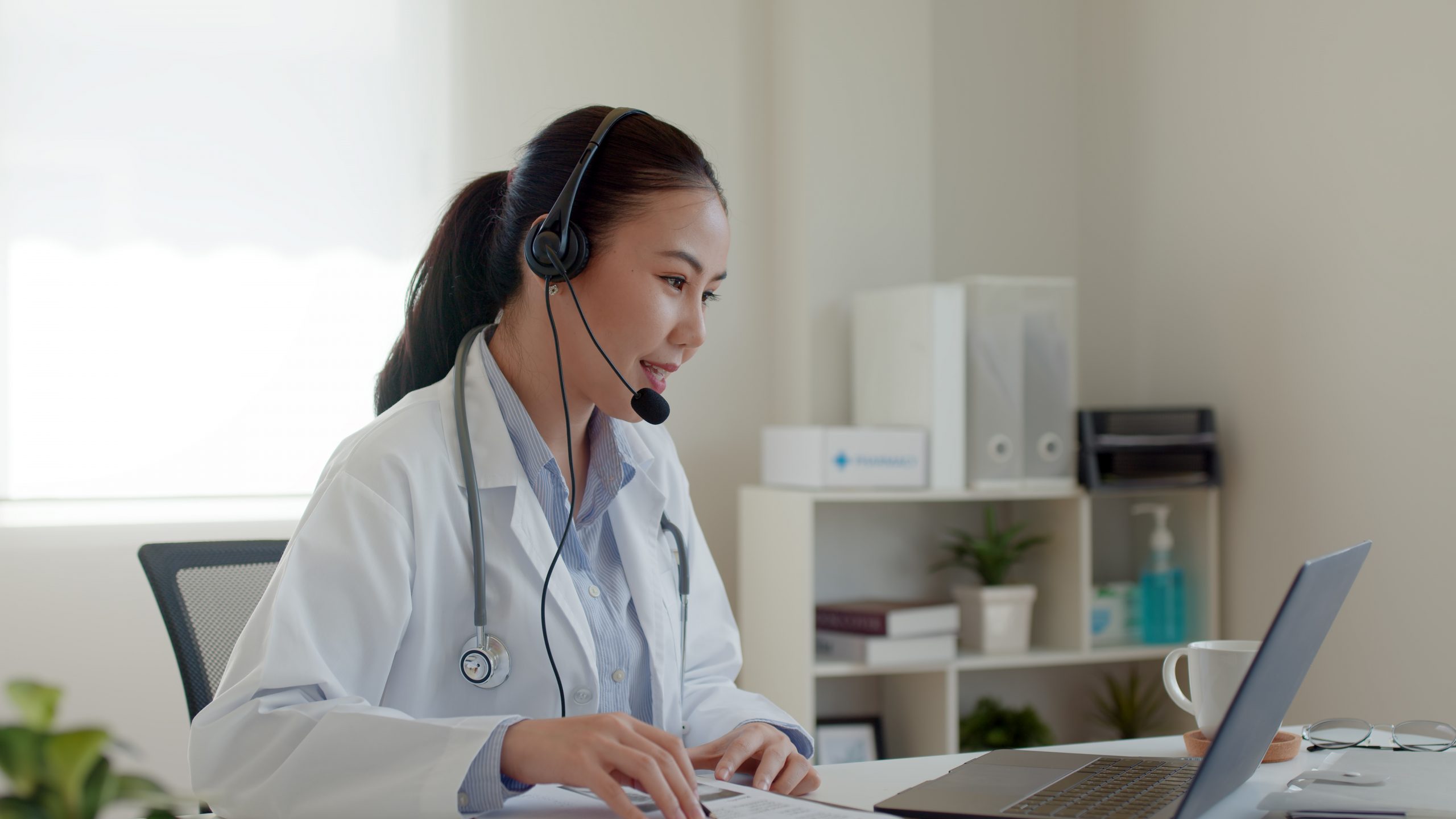 Young asia people or female doctor live talk looking and speakin Young asia people or female doctor live talk looking and speaking at laptop computer work in online clinic to help patient on digital telehealth telemedicine smart covid consult VoIP service app.